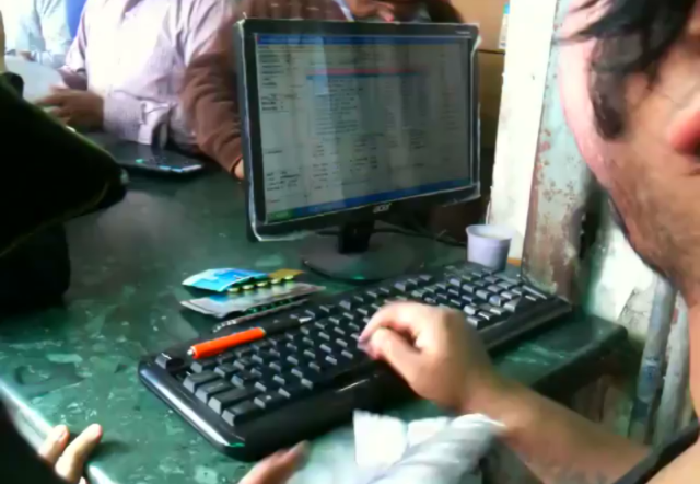 This receptionist at a busy pharmacy in India.